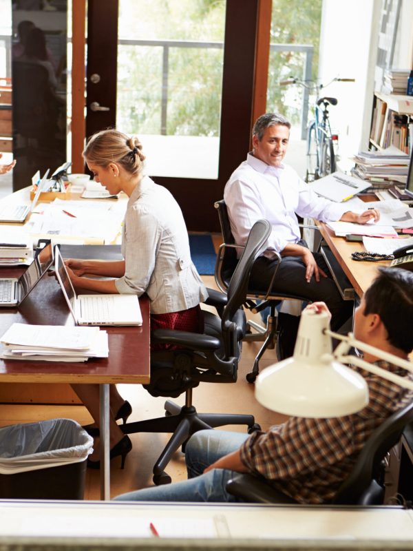 Interior Of Busy Architect's Office With Staff Working